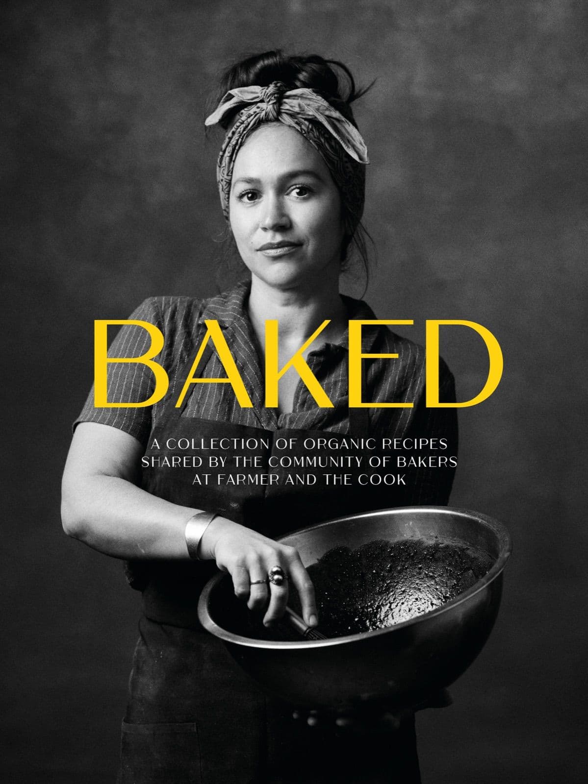 Baked cookbook — a baker holding a large bowl, photographed in black and white